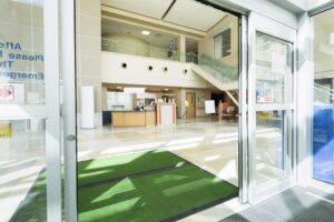 green rental mat at an entrance of a public building